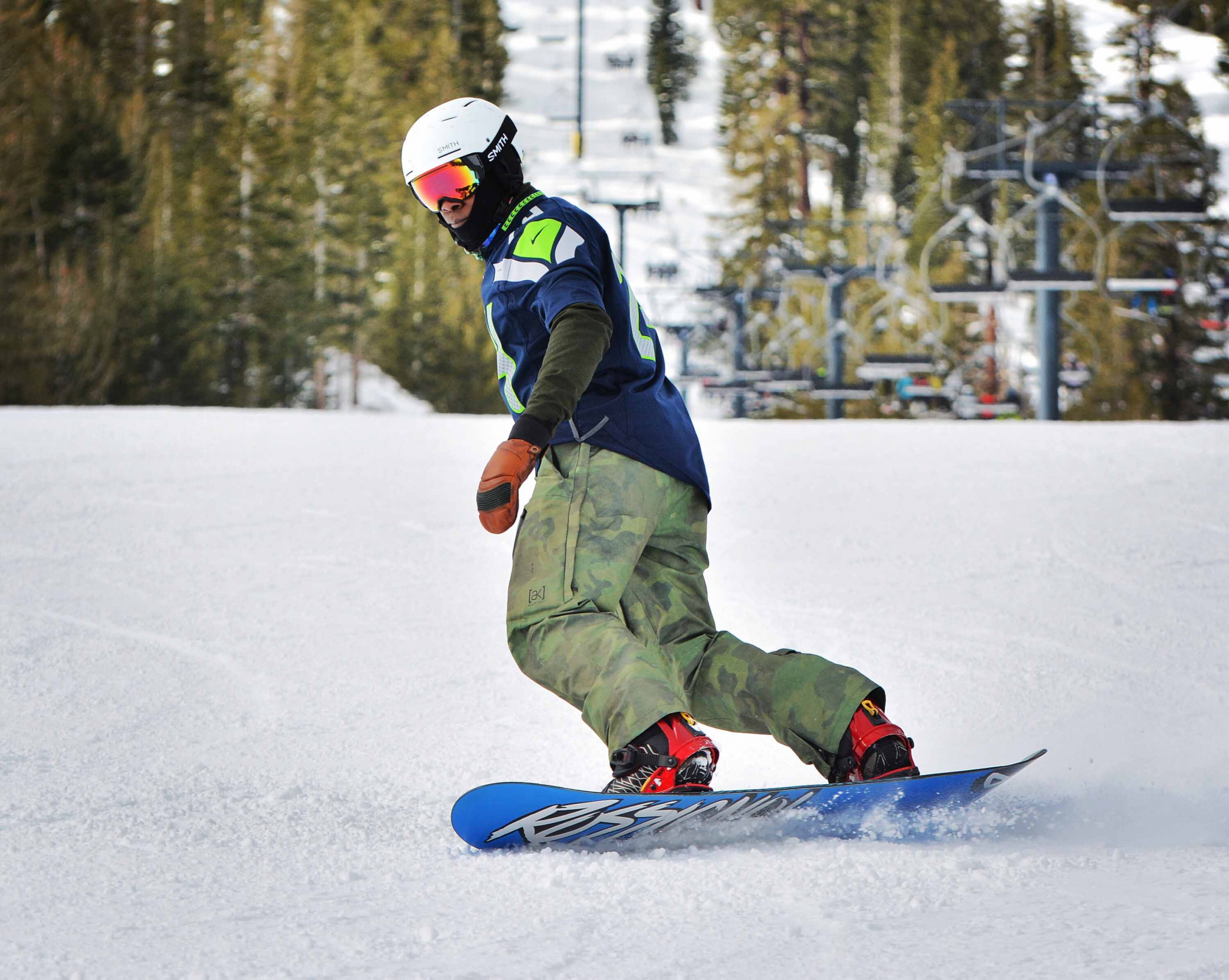 PSIA-AASI Member Marshal Titus snowboard in a Seattle Seahawks jersey