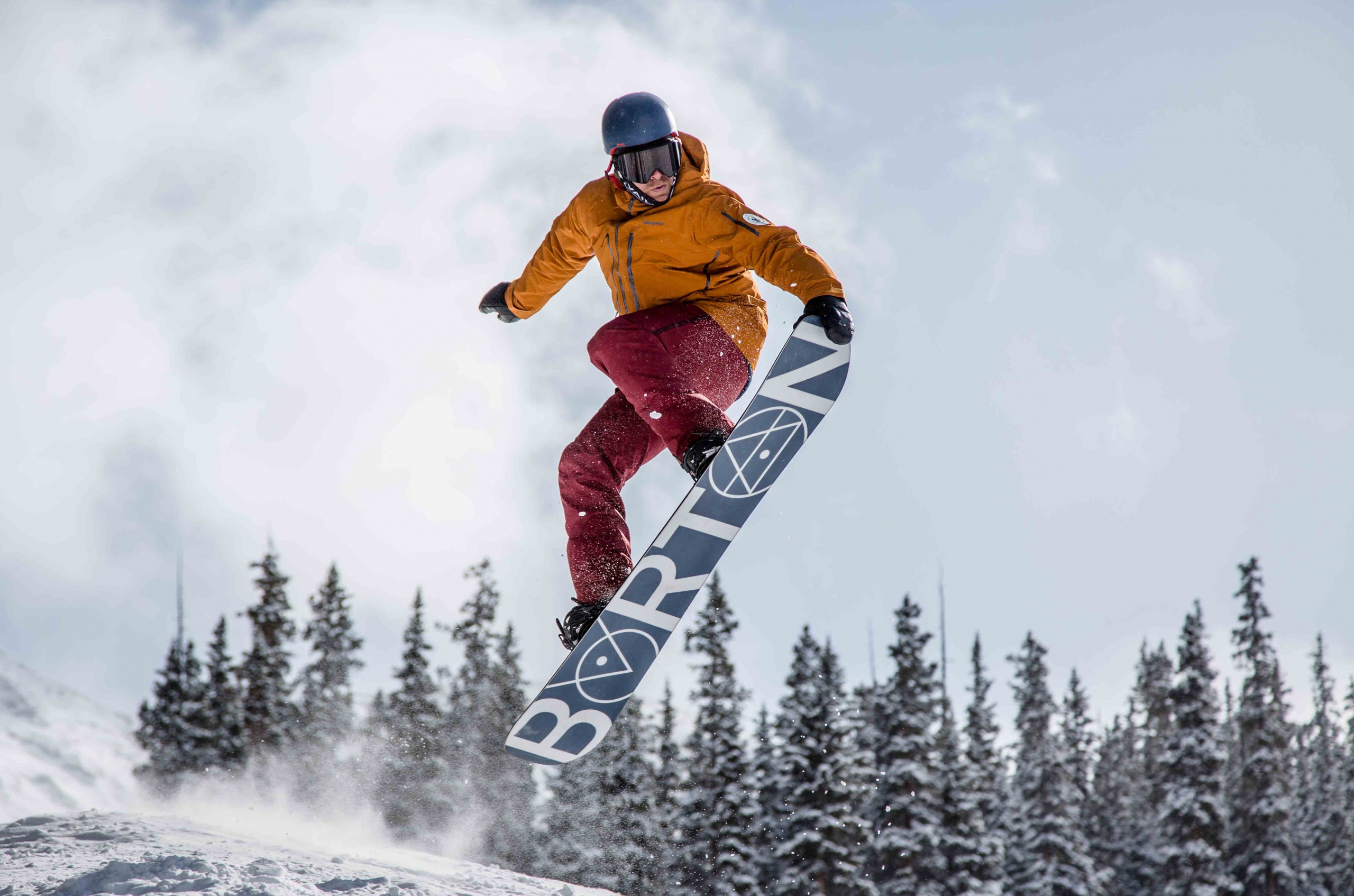 AASI Snowboard Team Member Chris Rogers does a nose grab on his Burton board