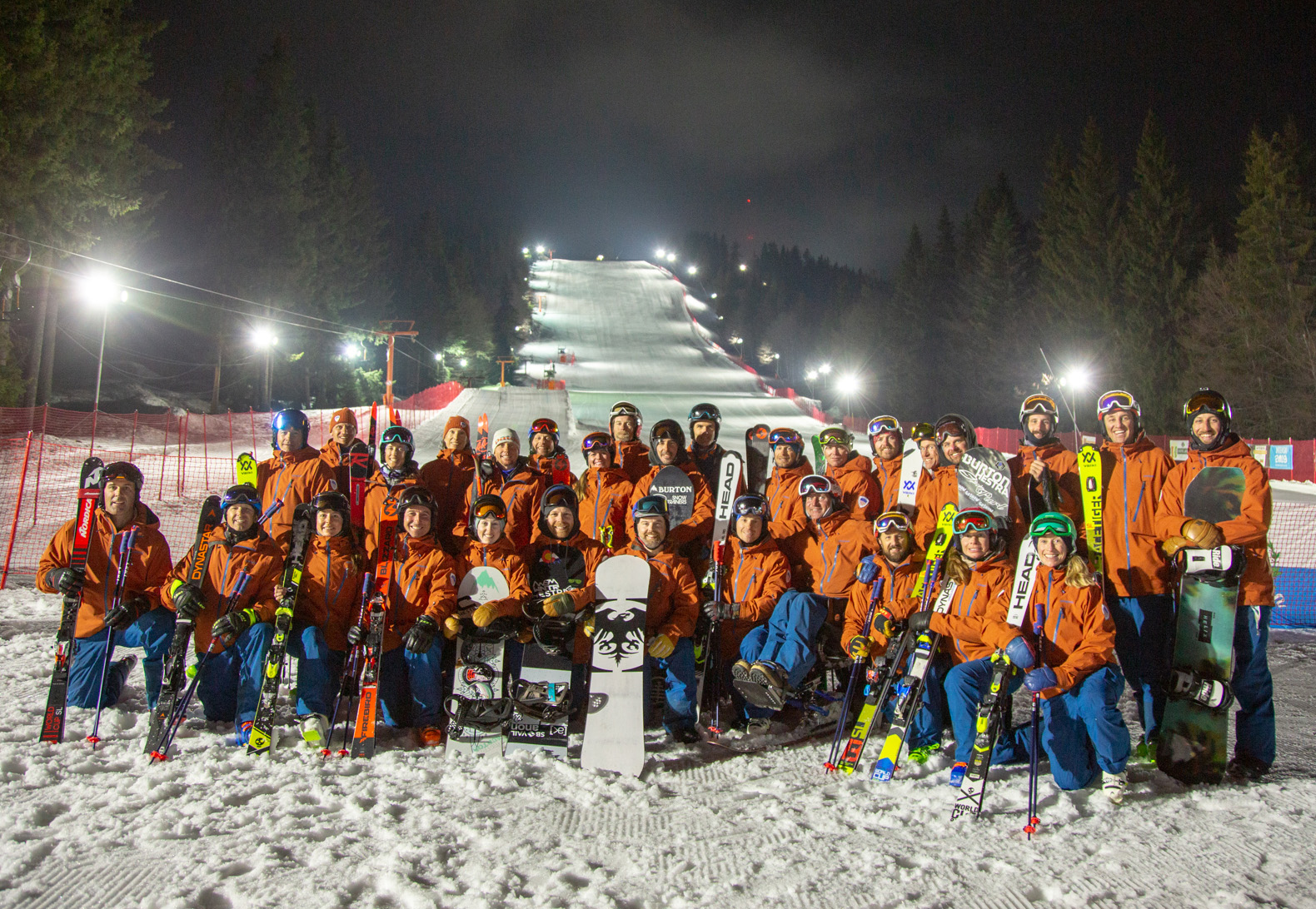 The PSIA-AASI National Team together at the base at the night skiing demo hill at Interski 2019