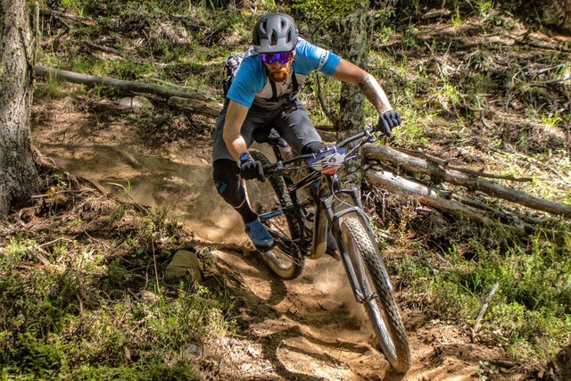 A professional mountain bikers rides a downhill course.